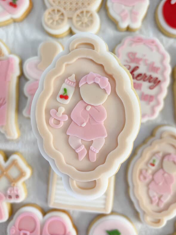 Baby on flat lay with cherry babh items debosser and cutter