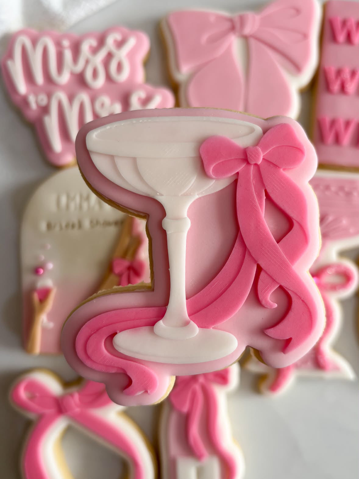 Cocktail glass with dainty bow debosser and cutter