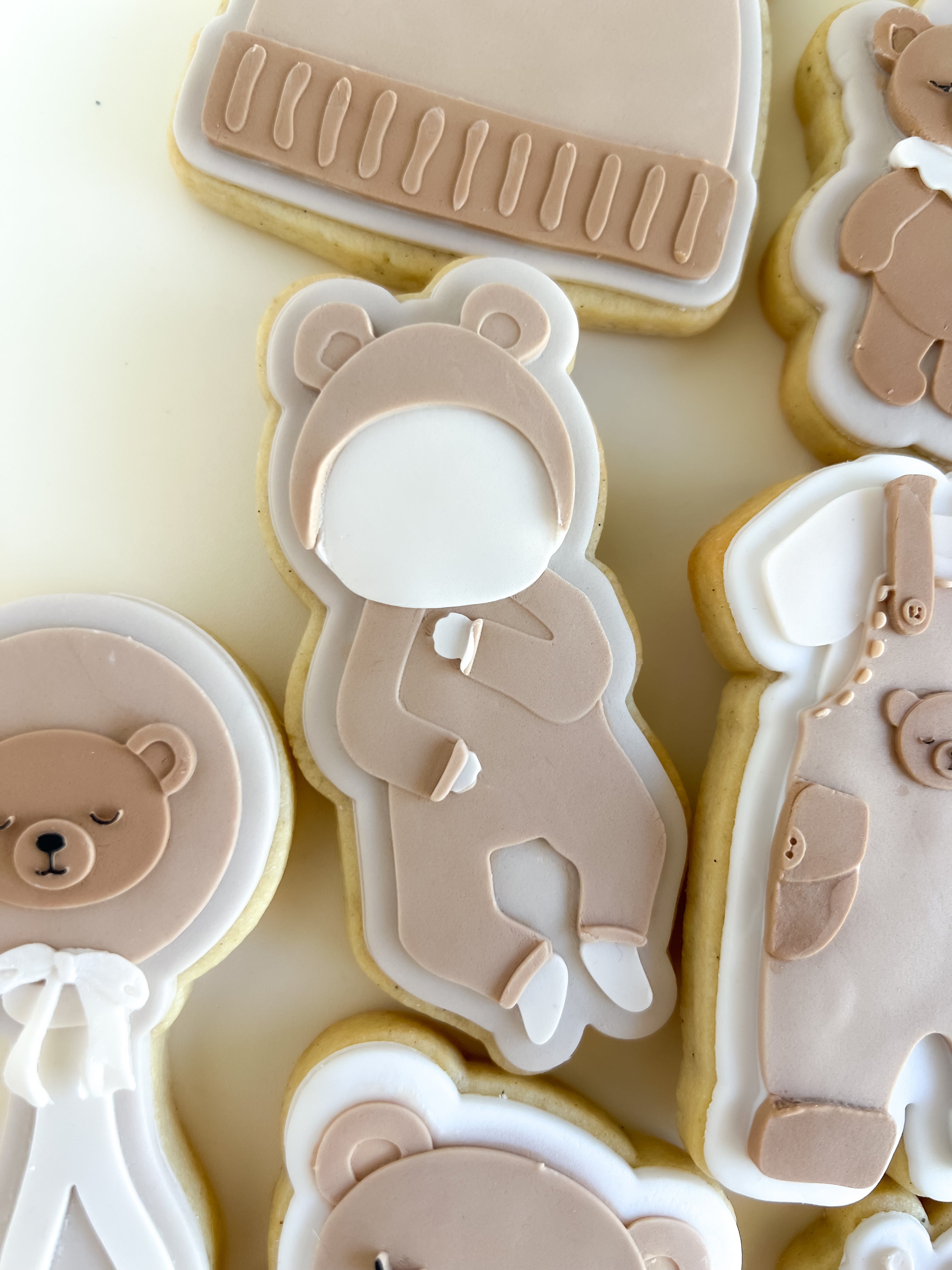 Baby laying in bear onesie debosser and cutter