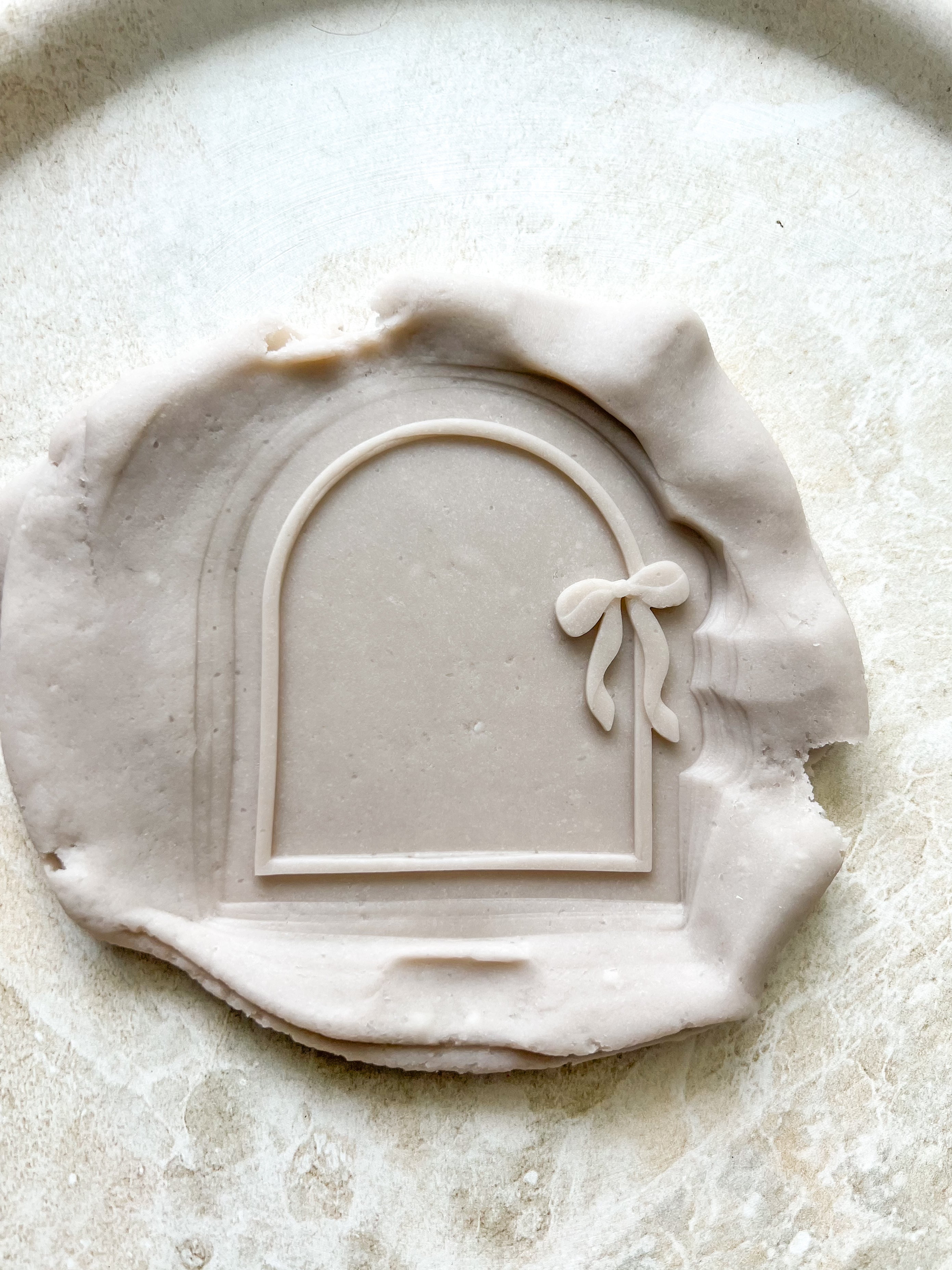 Arch with dainty bow debosser and cutter