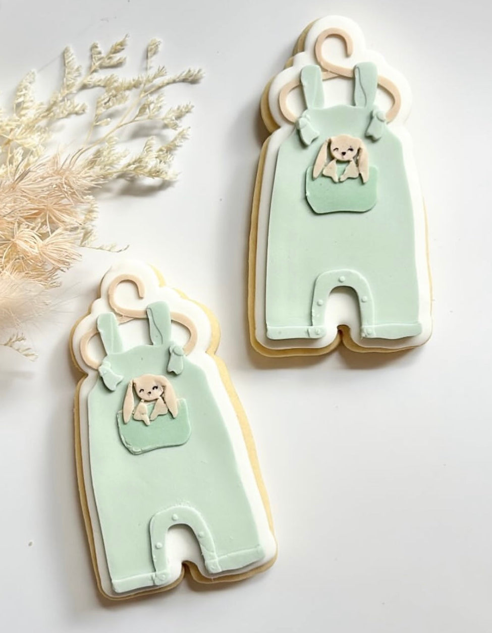 Tied baby onesie on hanger with bunny debosser and cutter