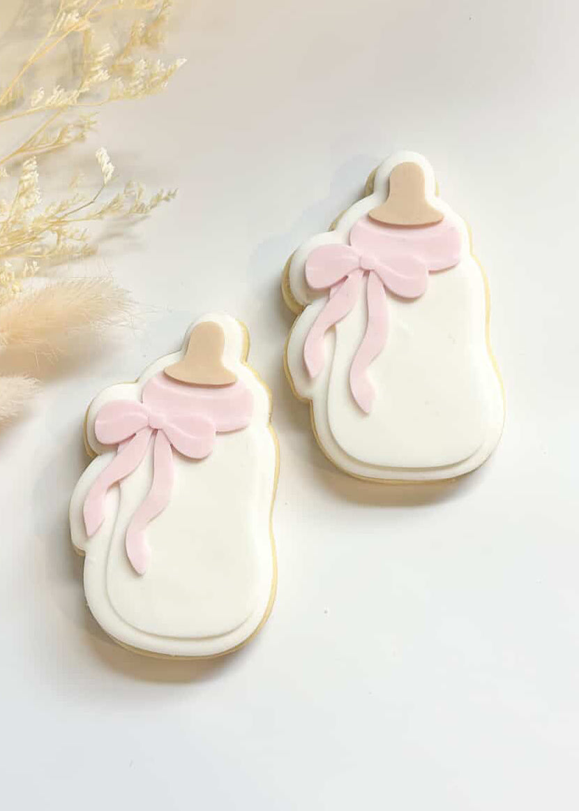 Baby bottle with bow debosser and cutter