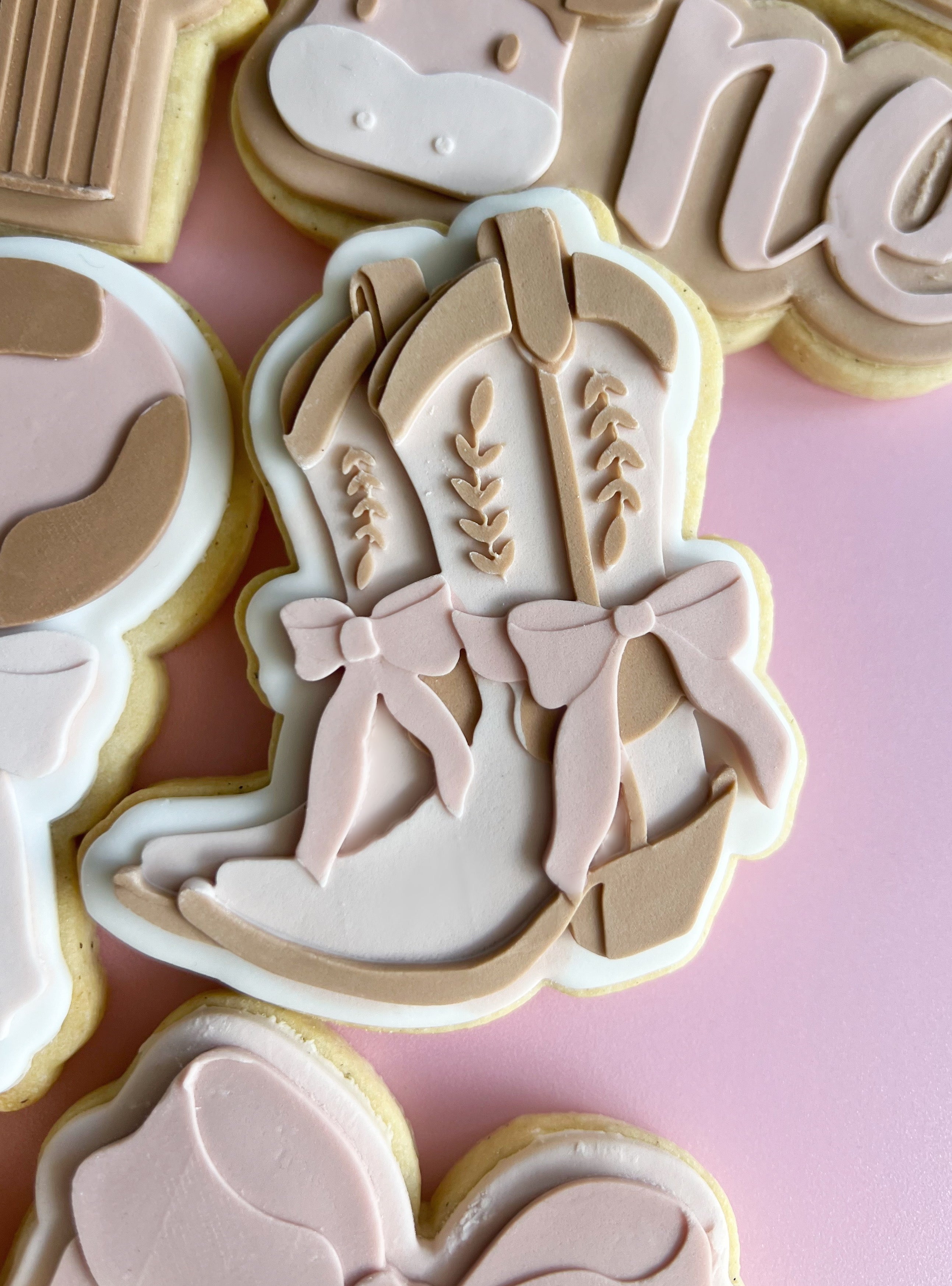 Cowgirl boots with long bows debosser and cutter