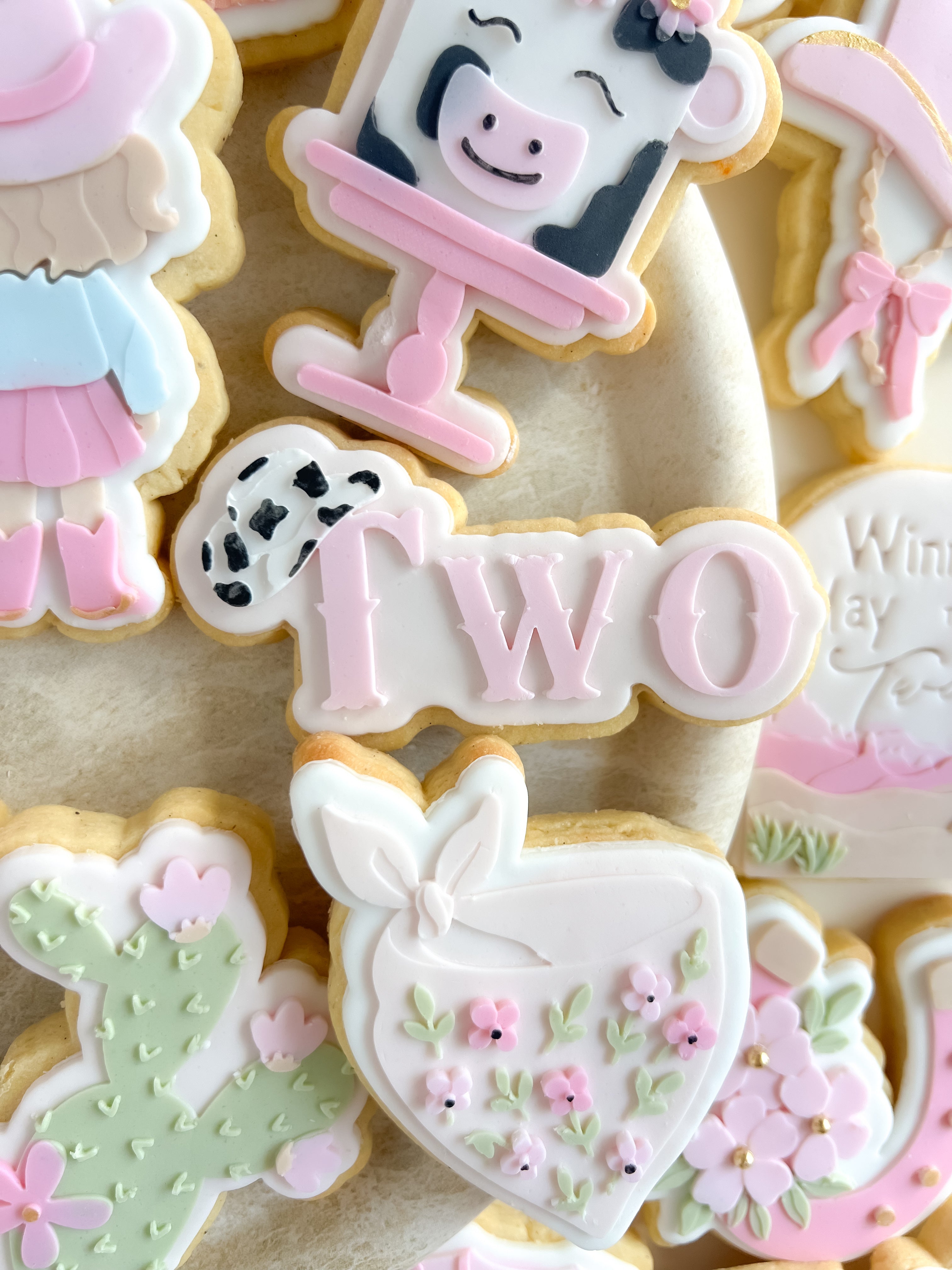 Two with cow print hat and cutter