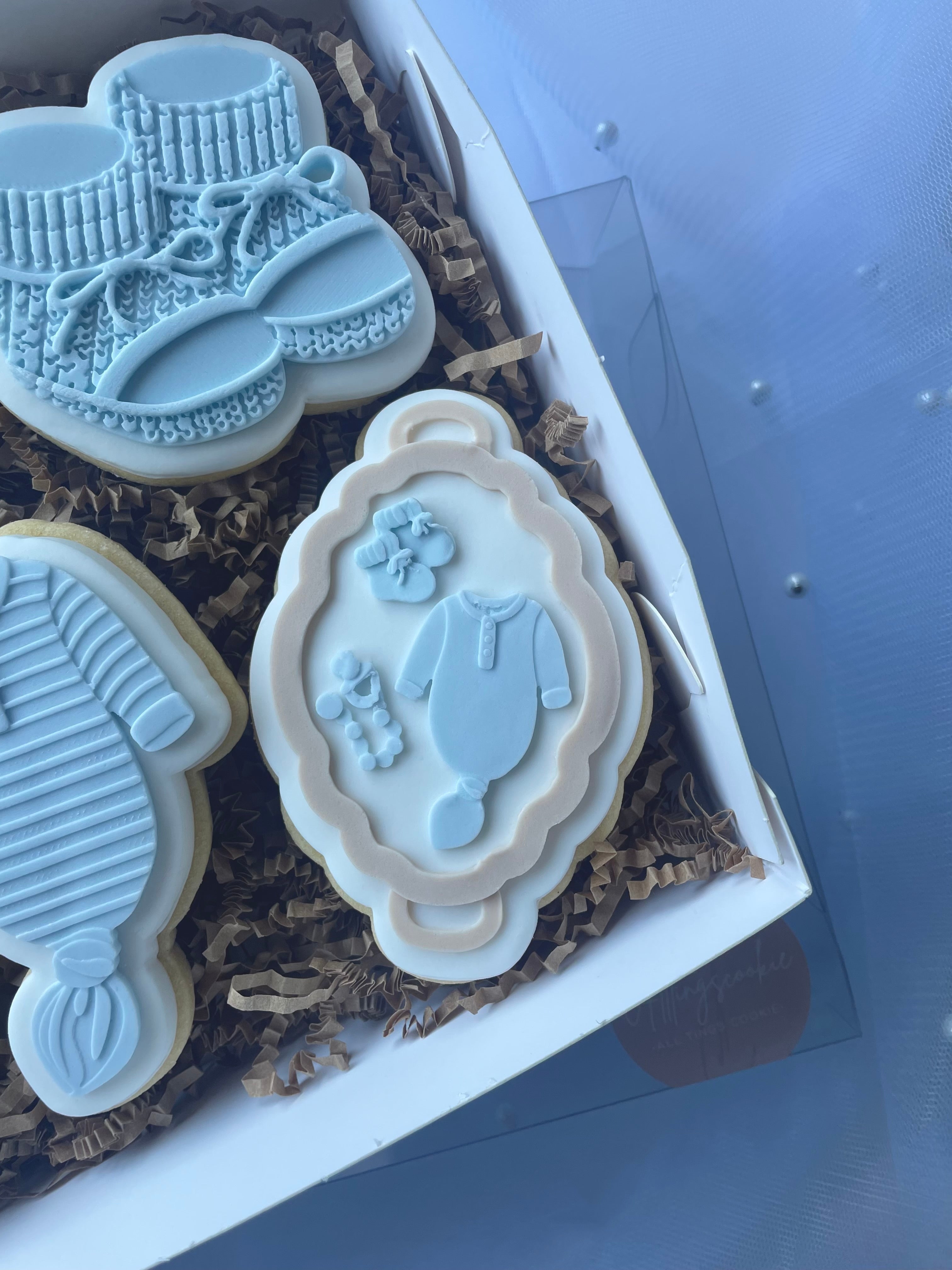 Neutral baby items on flat bassinet debosser and cutter