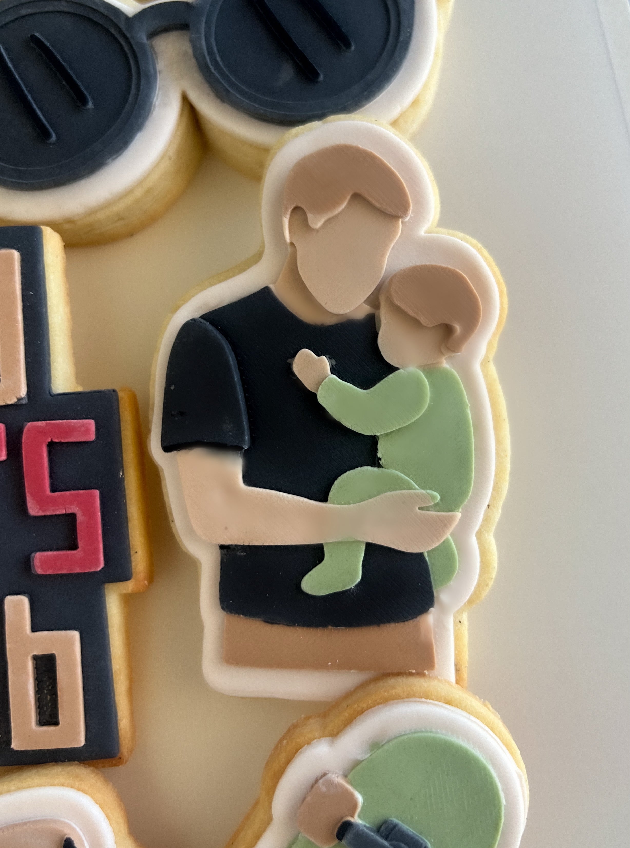 Dad holding baby debosser and cutter