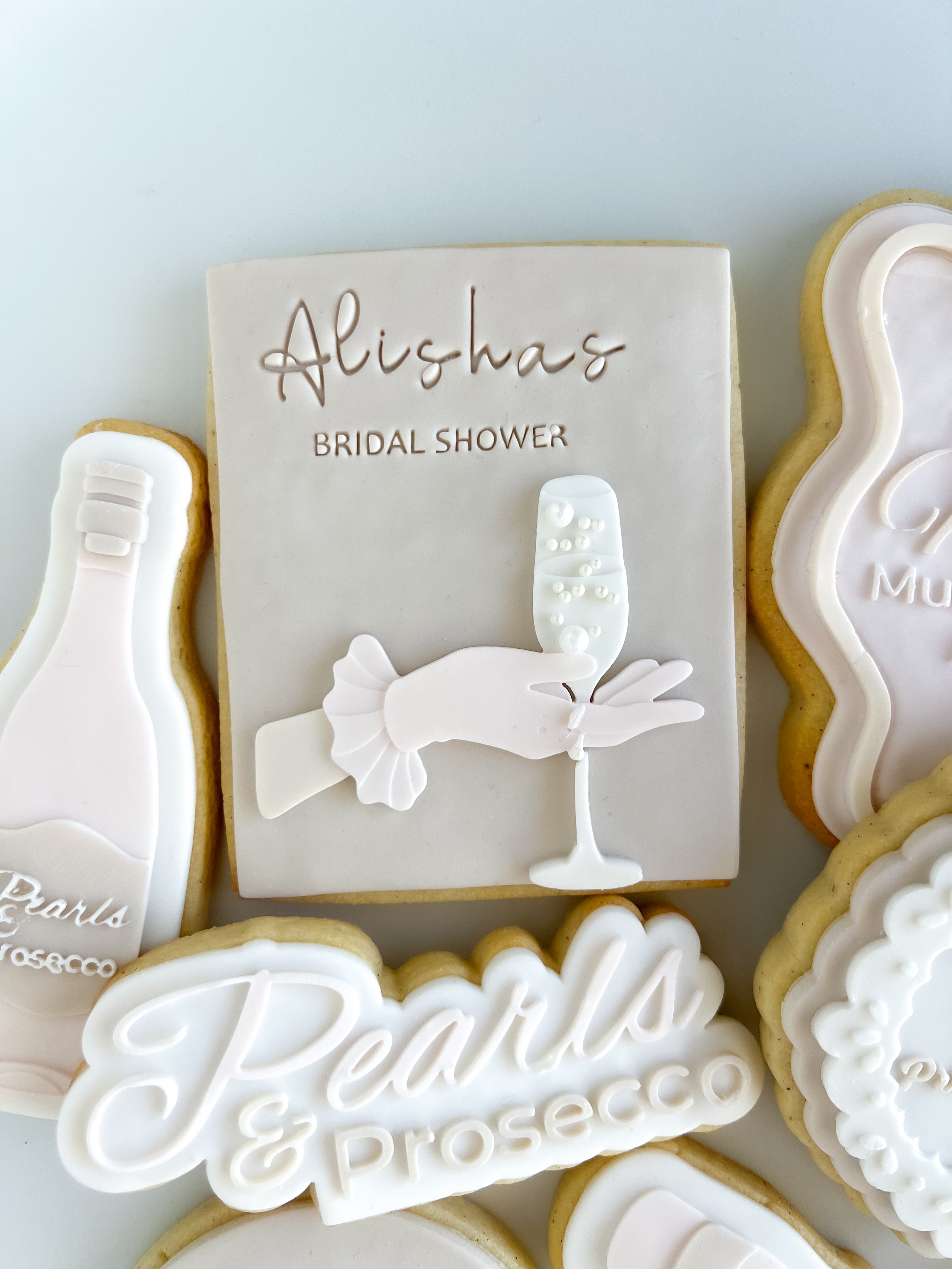 Hand with glove holding champagne glass debosser and rectangle cutter