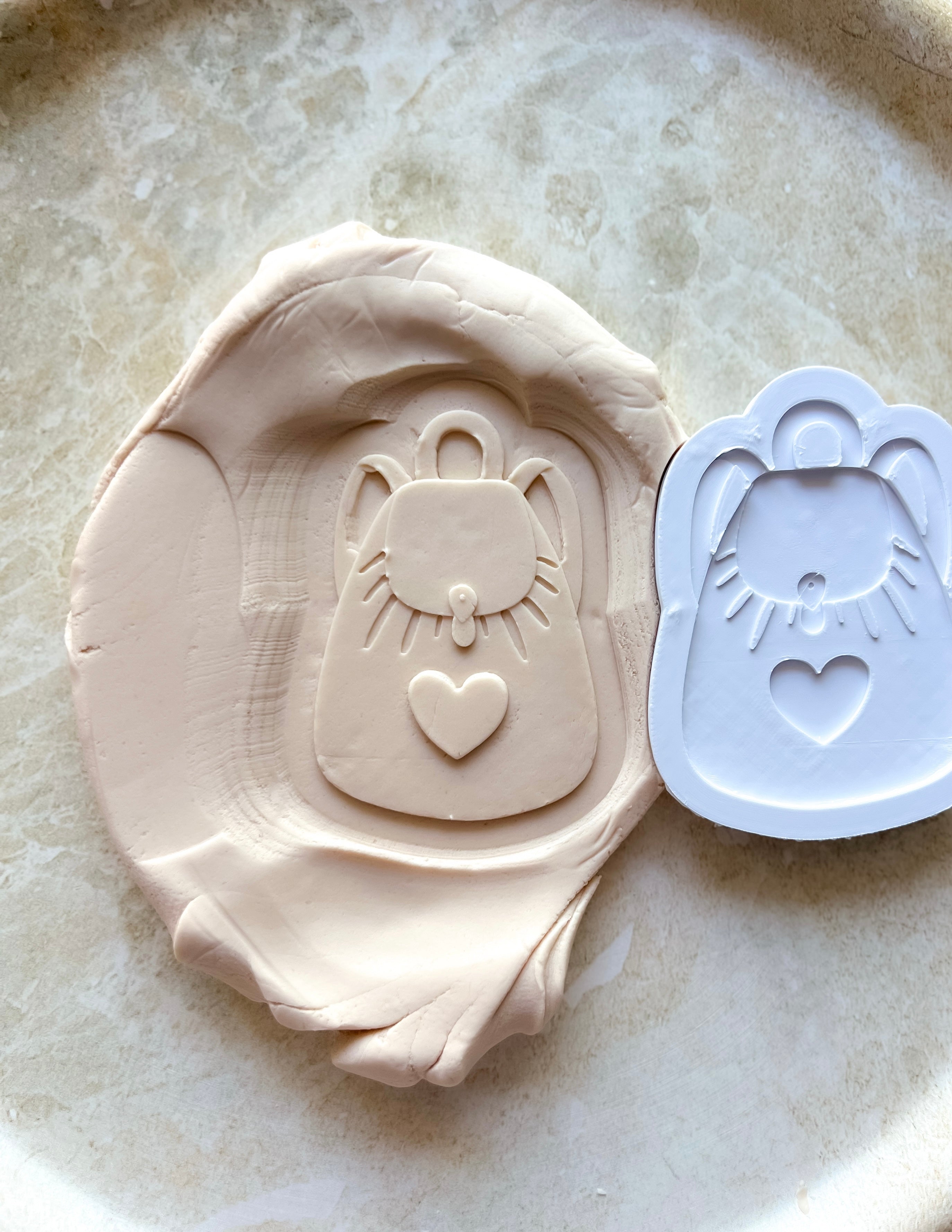 Backpack debosser and cutter