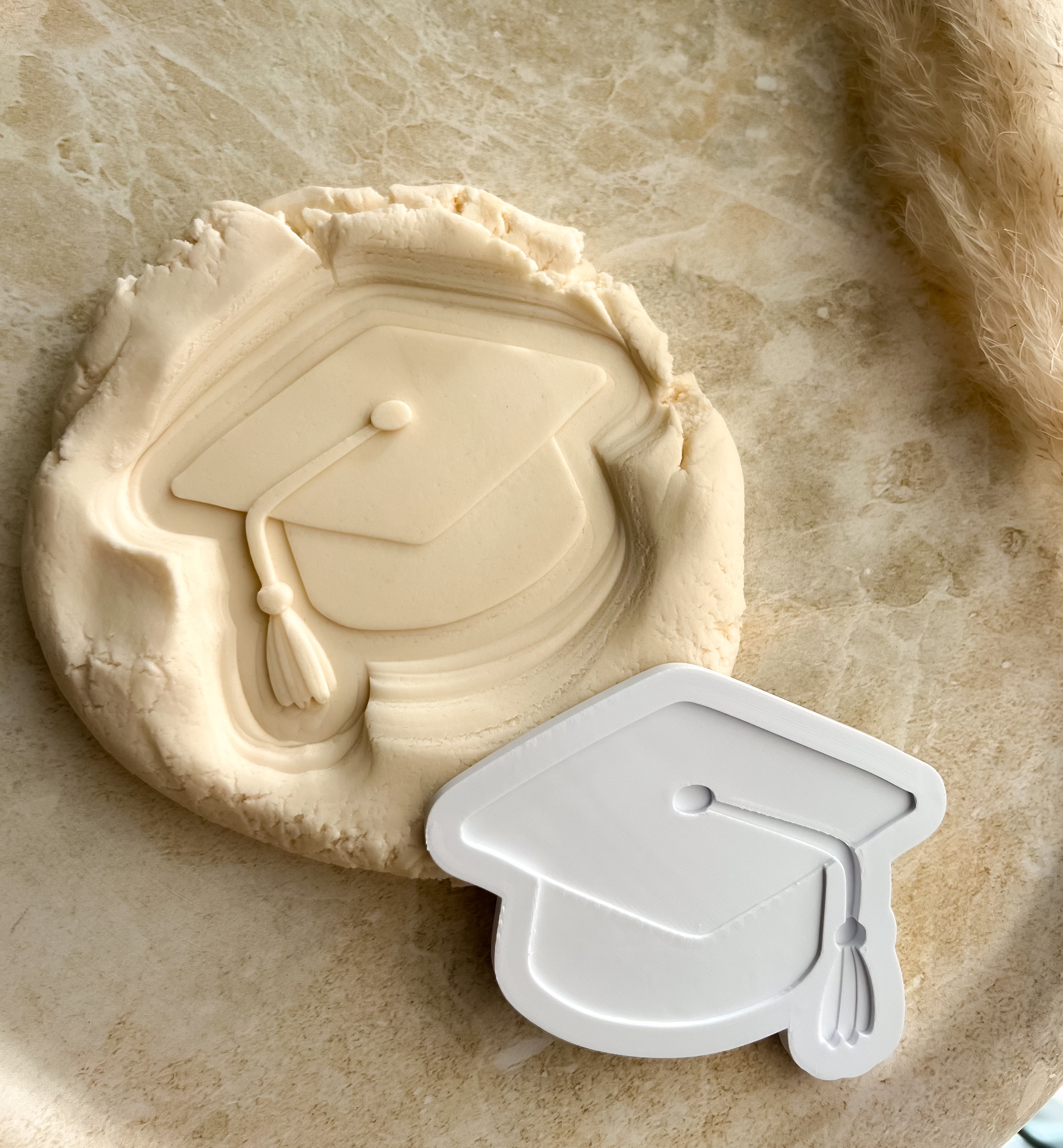 Graduation cap debosser and cutter