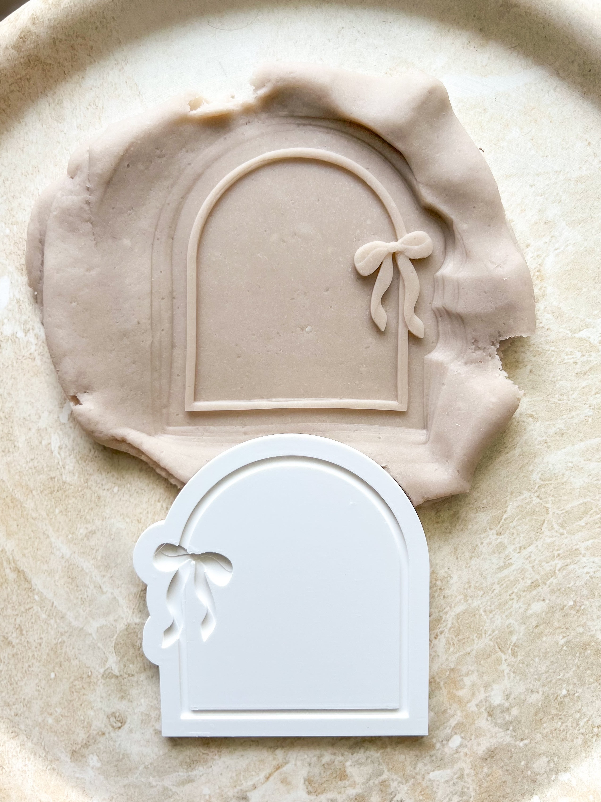 Arch with dainty bow debosser and cutter