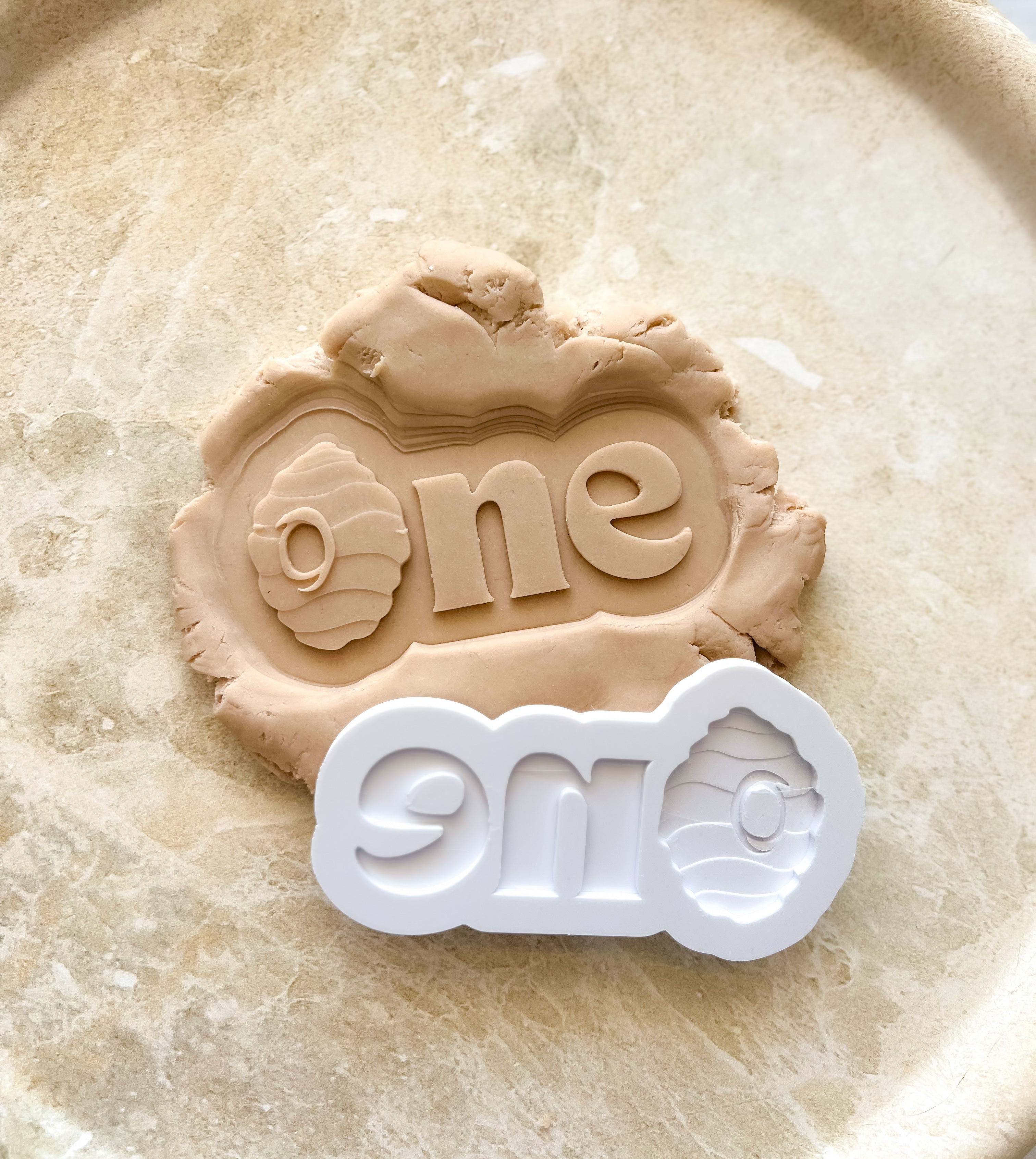 One word with bee hive debosser and cutter