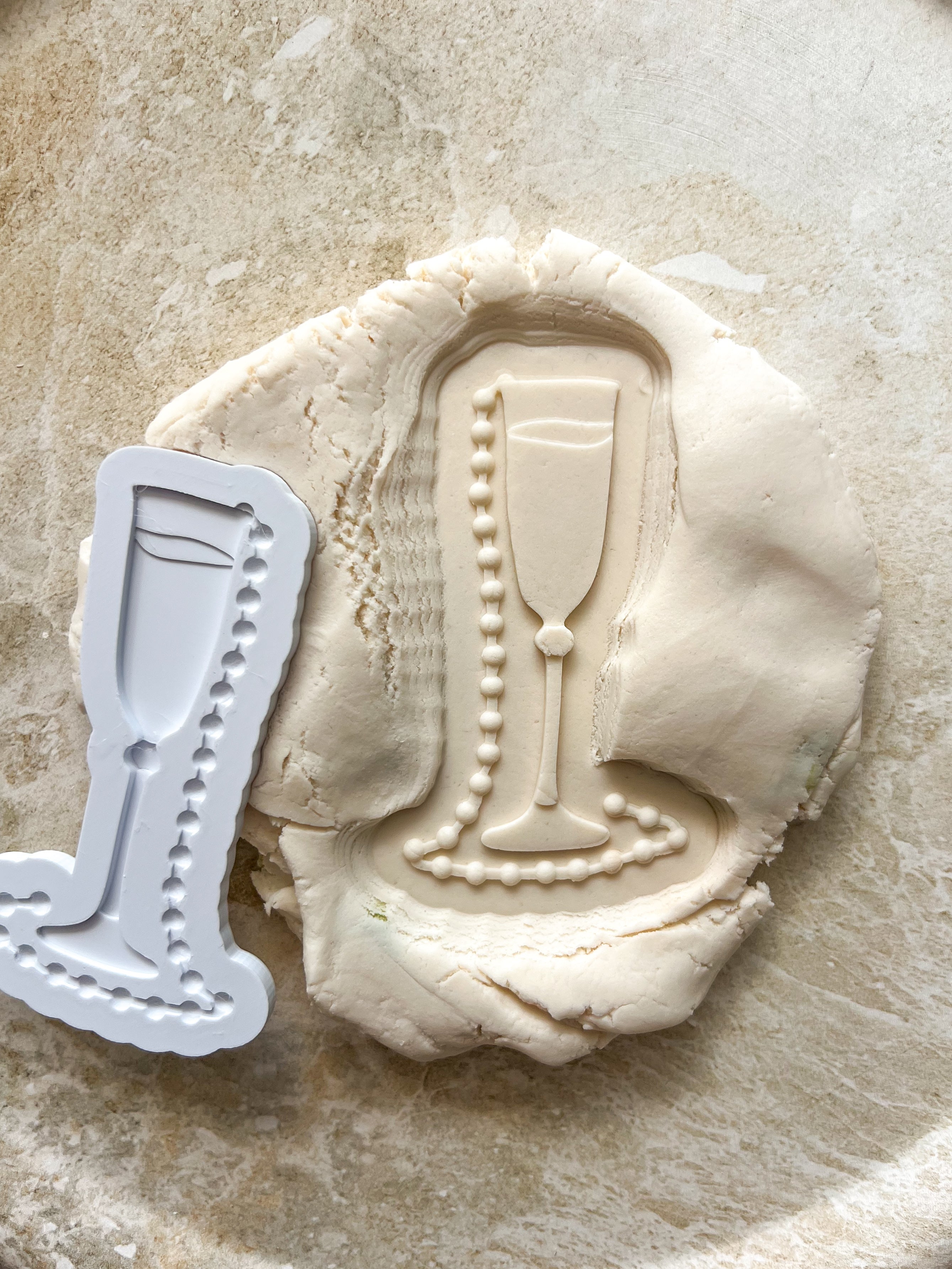 Champagne glass with pearls debosser and cutter