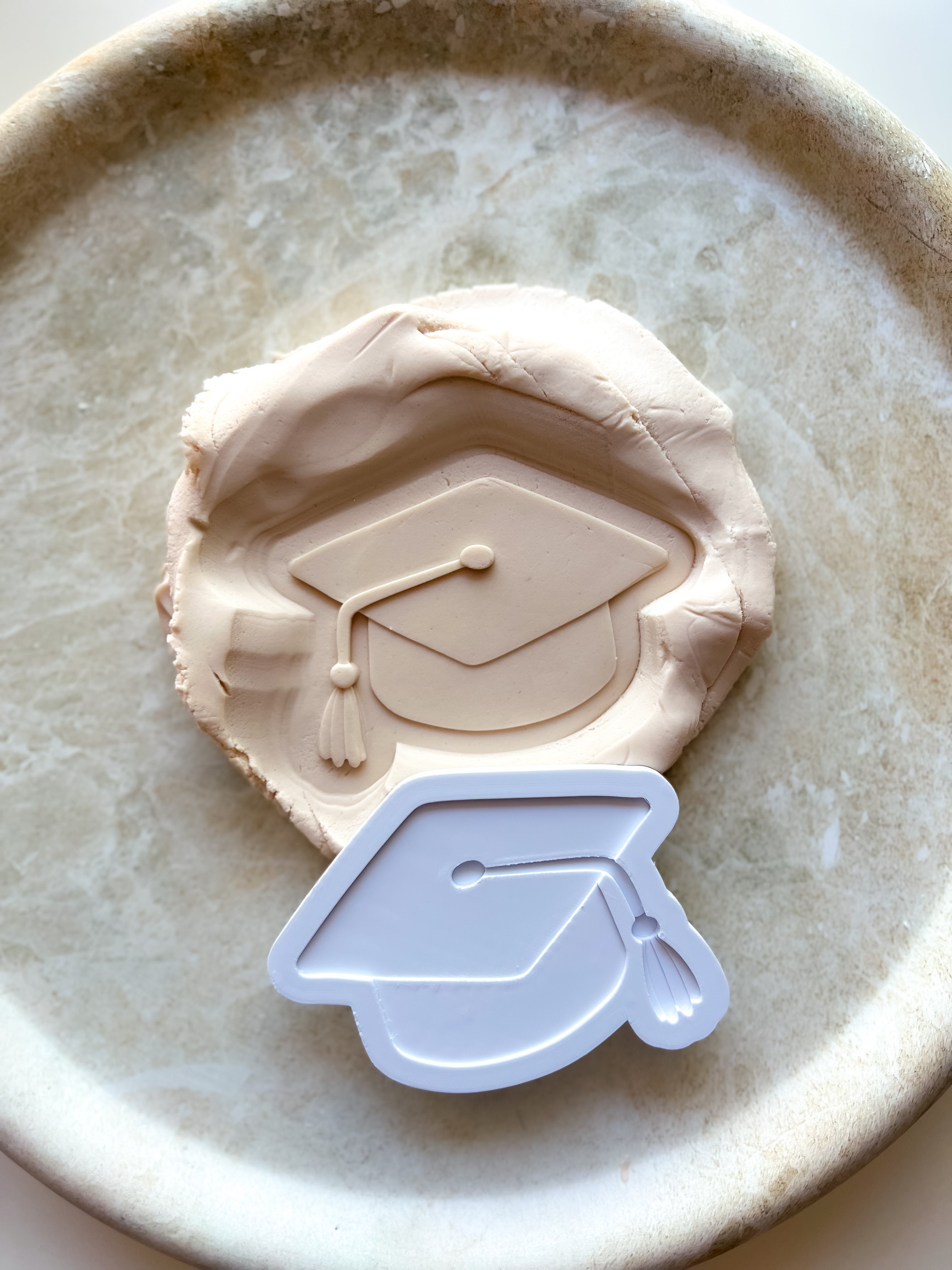 Graduation cap debosser and cutter