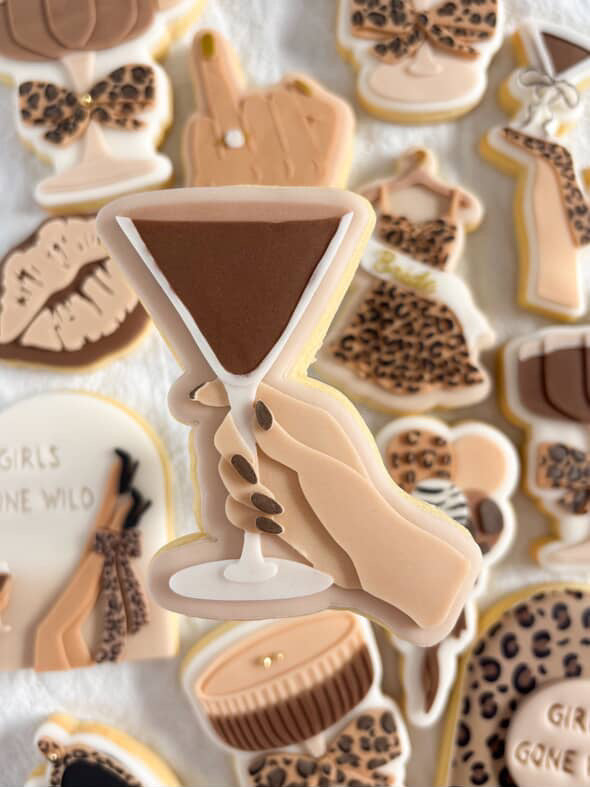 Hand holding martini glass debosser and cutter